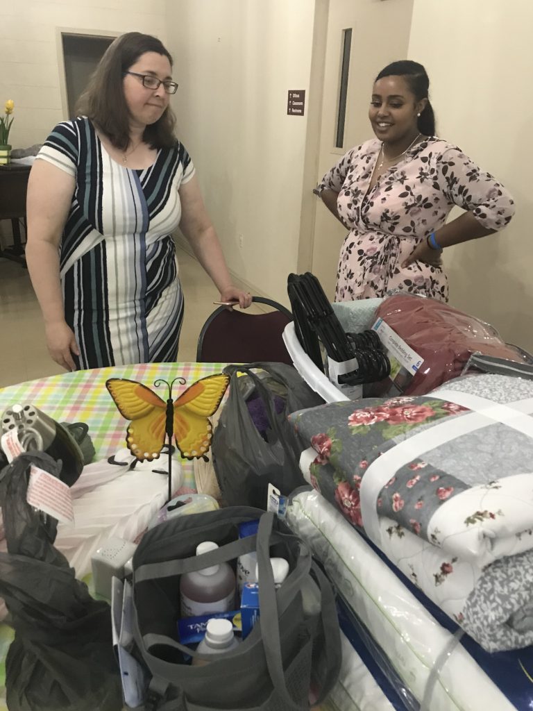 MMS teacher Rachel Hood and 2019 graduate Rebecca Getu take a moment to look through the gifts given on behalf of the Grundy Woman's Club.